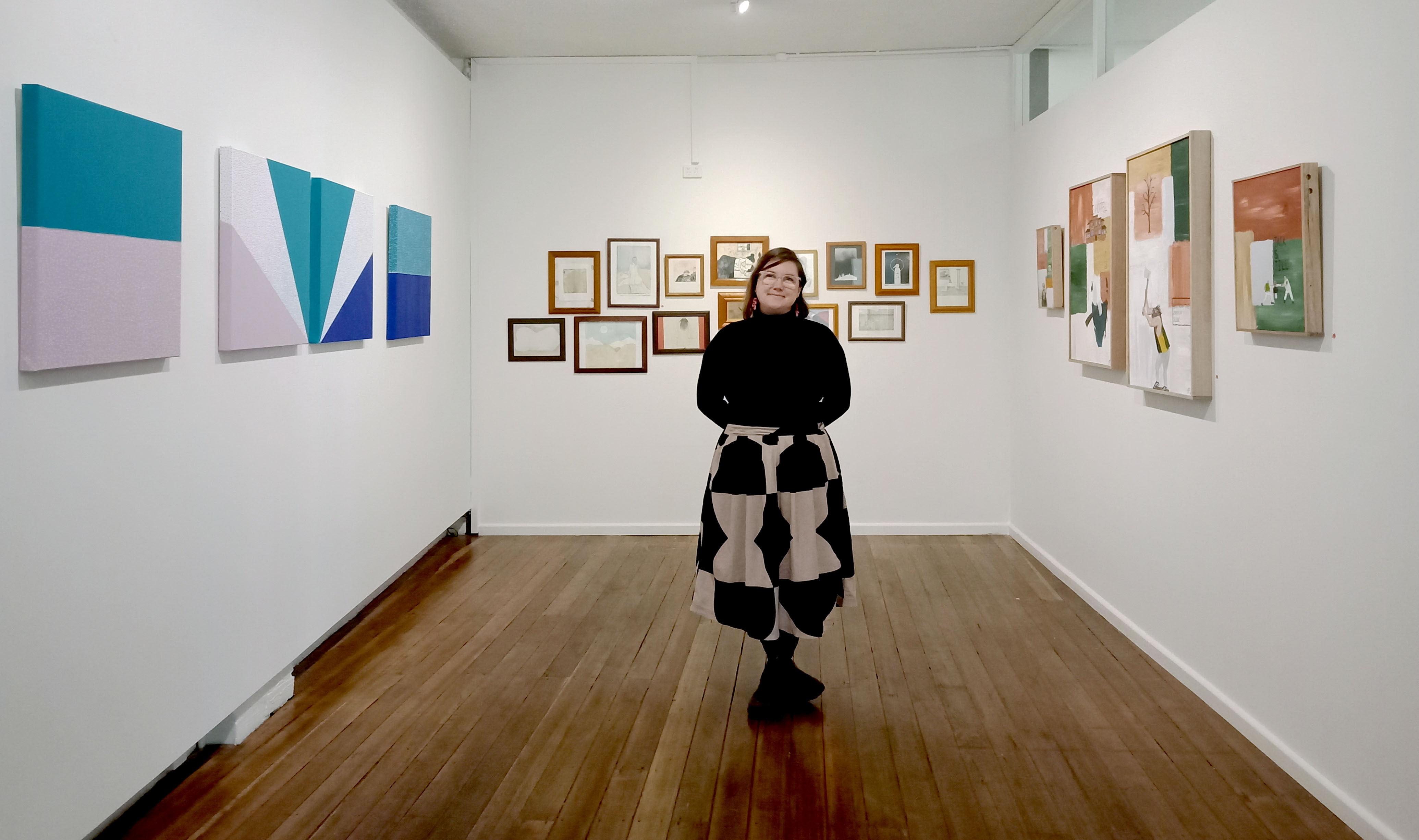 Photo of Shasta standing in tge Gallerie SeventyOne exhibition space